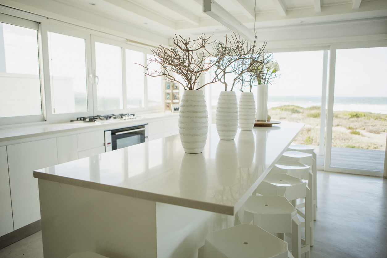 Timeless coastal kitchen with white cabinets and quartz countertops.